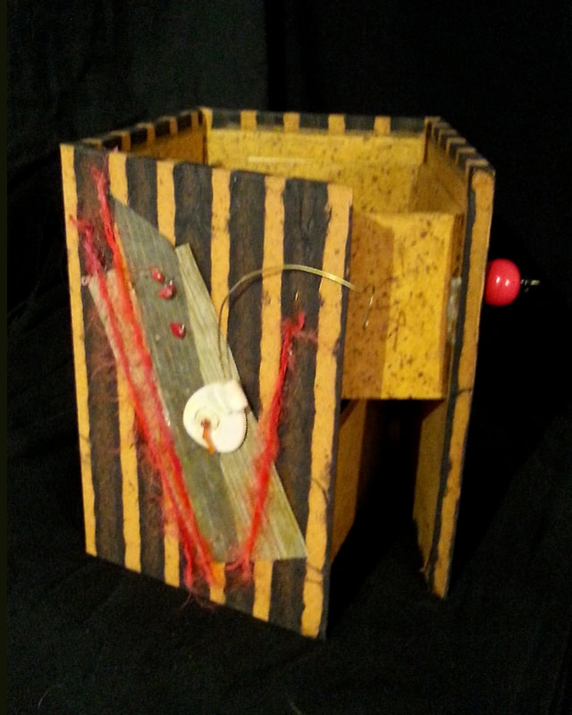 Pele Goddess Box, Outside Opening, 3-D Constructions:   LA Levy creates artistic constructions using recycled materials, handmade papers, textiles, her artwork, photos, found objects and more.  When the inspiration strikes, she has to build it.